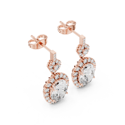 Side profile of rose gold oval ruby drop earrings.