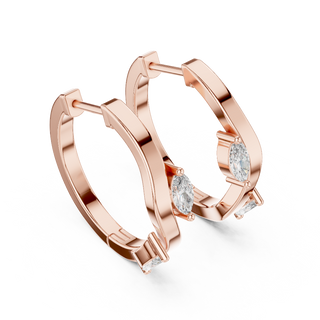 Side profile of rose gold sculptural fluid line diamond hoop earrings.
