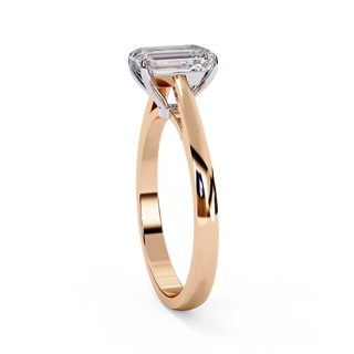 Side profile view of a rose gold radiant diamond four prong ring.