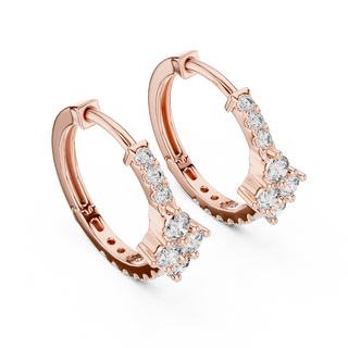 Side profile of rose gold floral motif diamond huggie hoop earrings.
