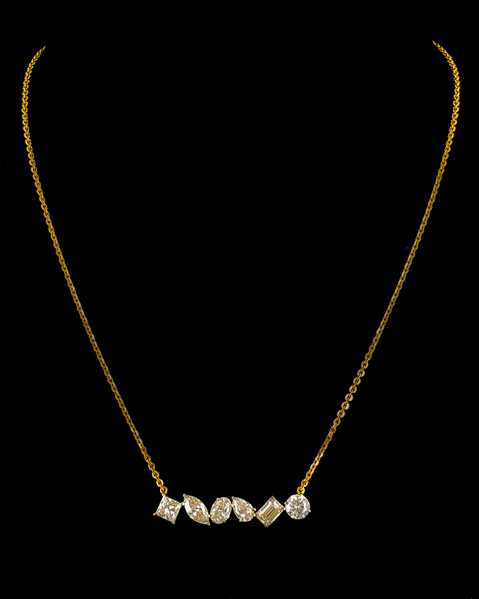 Yellow gold mixed-cut pendant with six round, pear, oval, marquise and emerald lab grown diamonds on black
