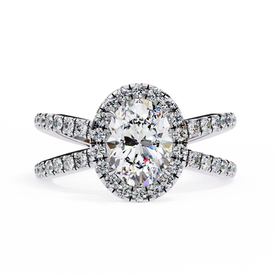 Diamond ring with a halo and side stones on a white background