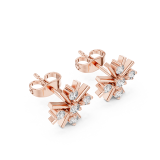 Side profile of rose gold snowflake diamond stud earrings.