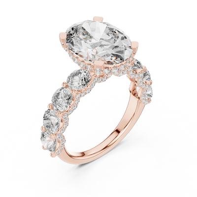 oval diamond round side-stone ring in rose gold

