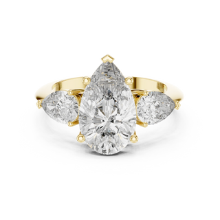 Pear three-stone engagement ring in yellow gold