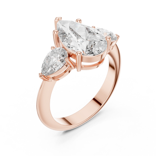 Pear three-stone engagement ring in rose gold