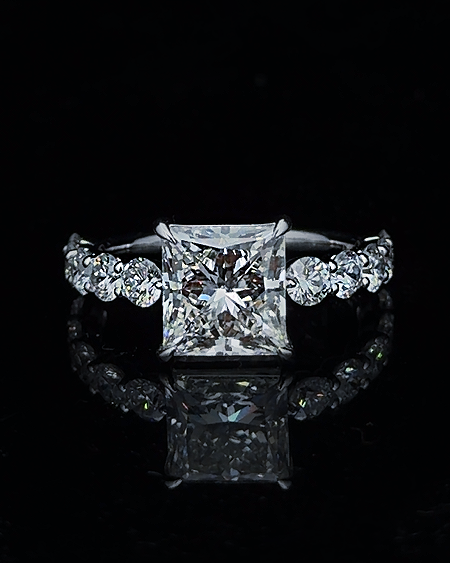 Main: White gold 4.20ct princess ring with round lab grown diamond shoulder stones on black
Detail: Close-up of 4.20ct princess lab grown diamond with substantial round diamond side stones
Side: White gold princess ring with four-prong centre and round lab grown diamonds across the shoulders