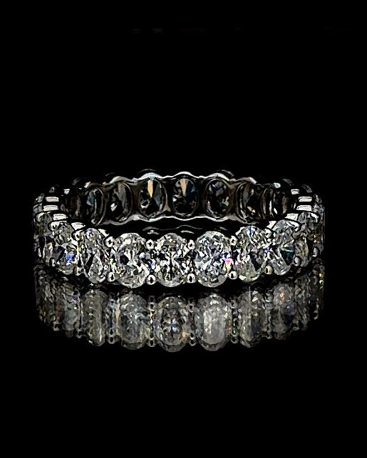 White gold full eternity ring with 2.29ct oval lab grown diamonds on black
