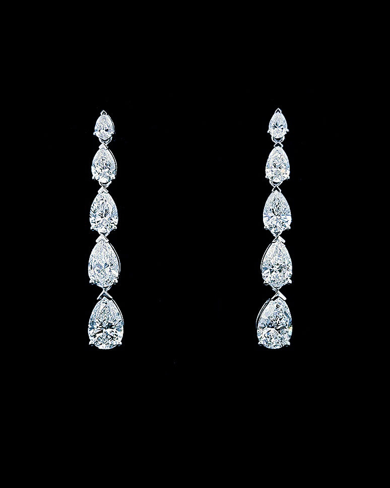 Main: White gold graduated pear drop earrings with 5.29ct lab grown diamonds on black
Detail: Close-up of five graduated pear lab grown diamonds forming each white gold drop earring
Side: White gold pear diamond drop earrings showing articulated settings and post-and-butterfly fastening