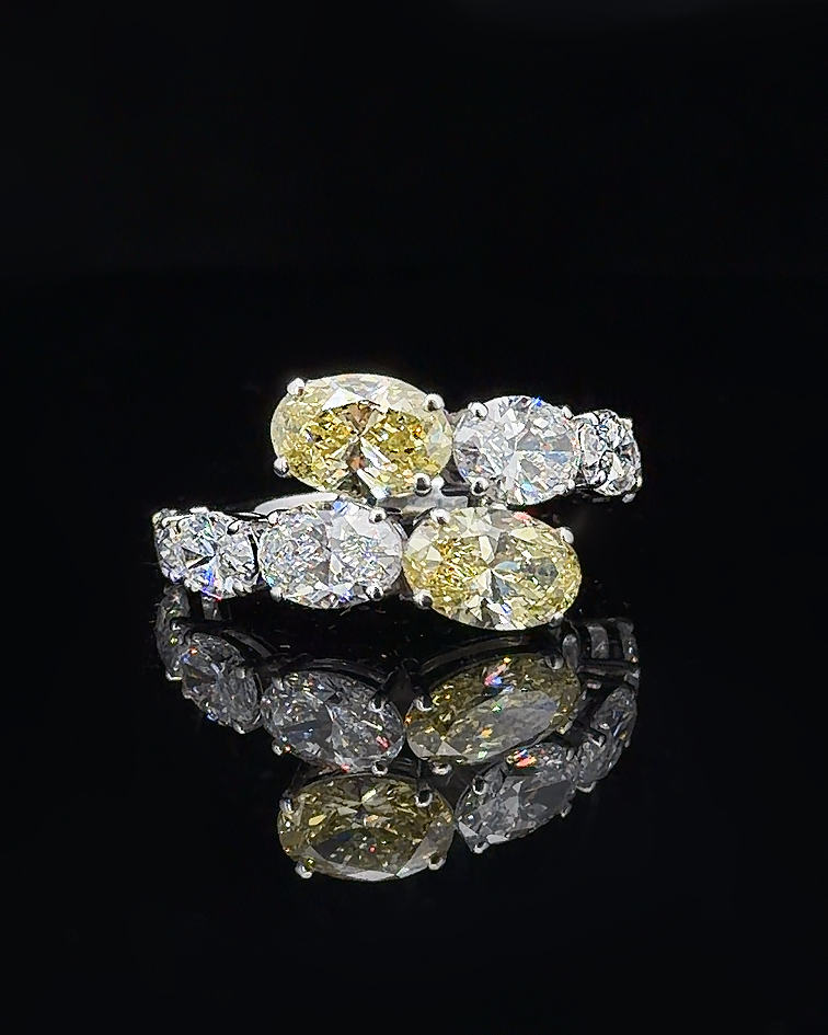 Main: White gold oval mosaic ring with eight graduated lab grown diamonds on black
Detail: Close-up of graduated oval lab grown diamonds arranged across an asymmetric white gold setting
Side: White gold statement ring showing two-row oval lab grown diamond composition and raised prong settings