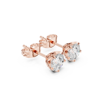 Side profile of rose gold floral-inspired basket solitaire diamond studs.