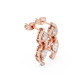 Side profile of rose gold elegant flowing curves pear diamond drop earrings.