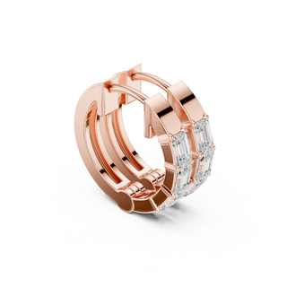 Side profile of rose gold emerald diamond huggie hoop earrings.