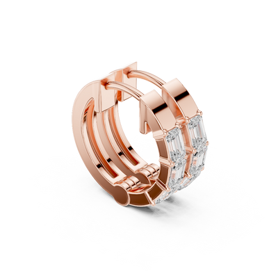 Side profile of rose gold emerald diamond huggie hoop earrings.