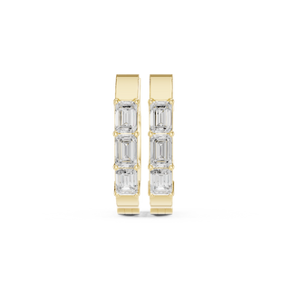 Front view of Urban Edge emerald cut diamond huggie earrings in yellow gold.