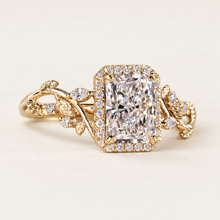 Radiant cut lab grown diamond engagement ring with rectangular pavé halo, floral vine cathedral shoulders, marquise diamond accents and polished yellow gold.