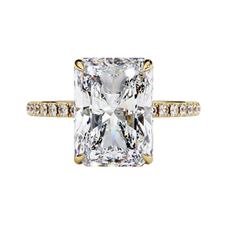 Front view of radiant cut diamond engagement ring in warm yellow gold.