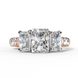 Front view of a rose gold radiant cut three-stone diamond engagement ring.