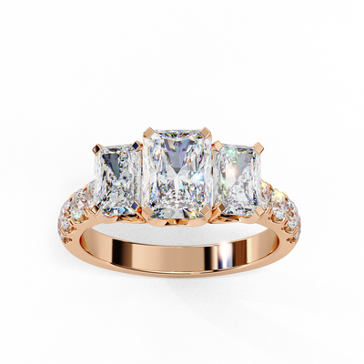 Top-down view of a rose gold radiant cut three-stone diamond engagement ring highlighting the horizontal stone alignment.