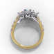 Side profile view of a yellow gold radiant cut three-stone diamond engagement ring with an open basket setting.
