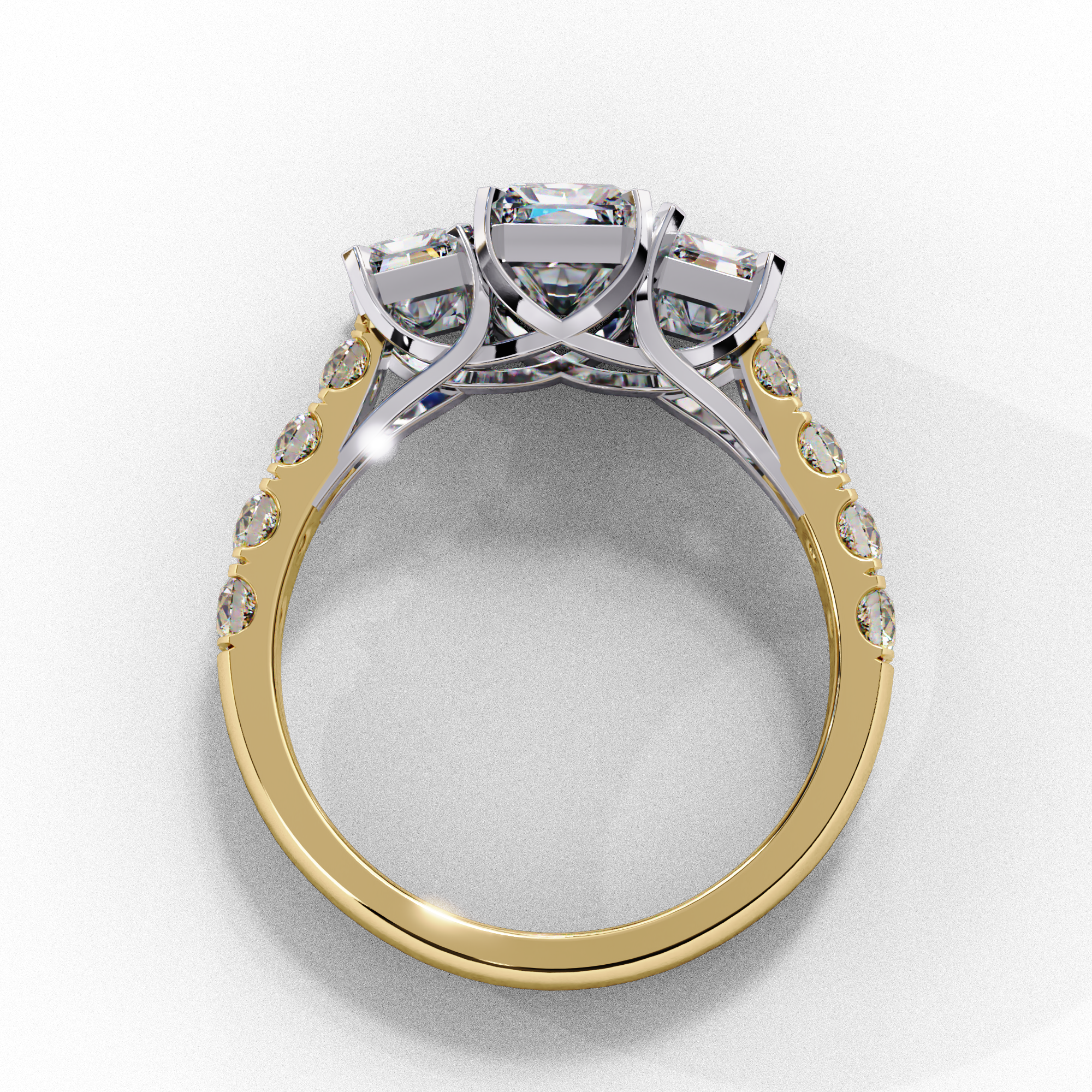 Side profile view of a yellow gold radiant cut three-stone diamond engagement ring with an open basket setting.