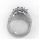 Side profile view of a white gold radiant cut three-stone diamond engagement ring with an open basket setting.