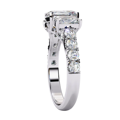 Side profile view of a white gold radiant cut three-stone diamond ring showing the diamond-accented band.