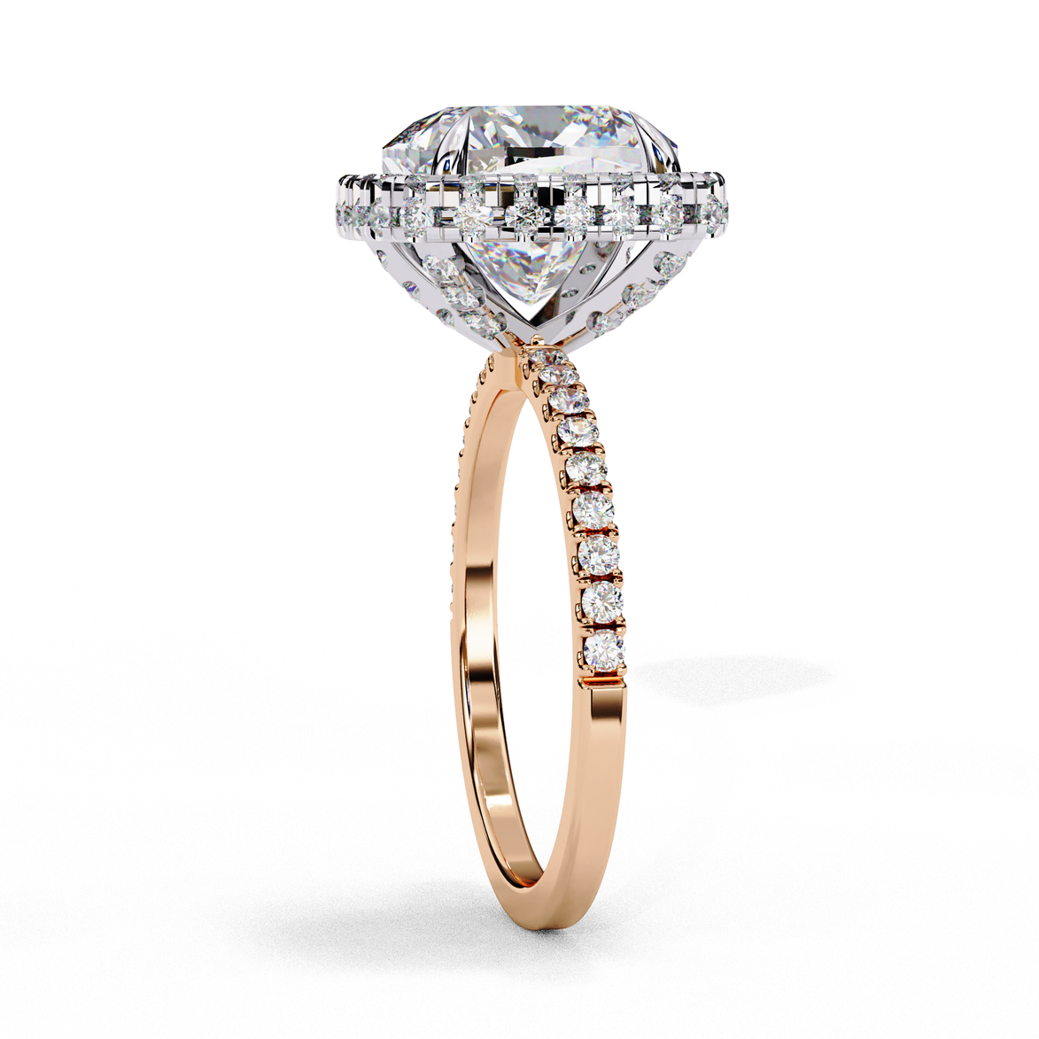 Close-up angled shot of a rose gold cushion cut diamond double halo engagement ring highlighting the pavé shoulders.