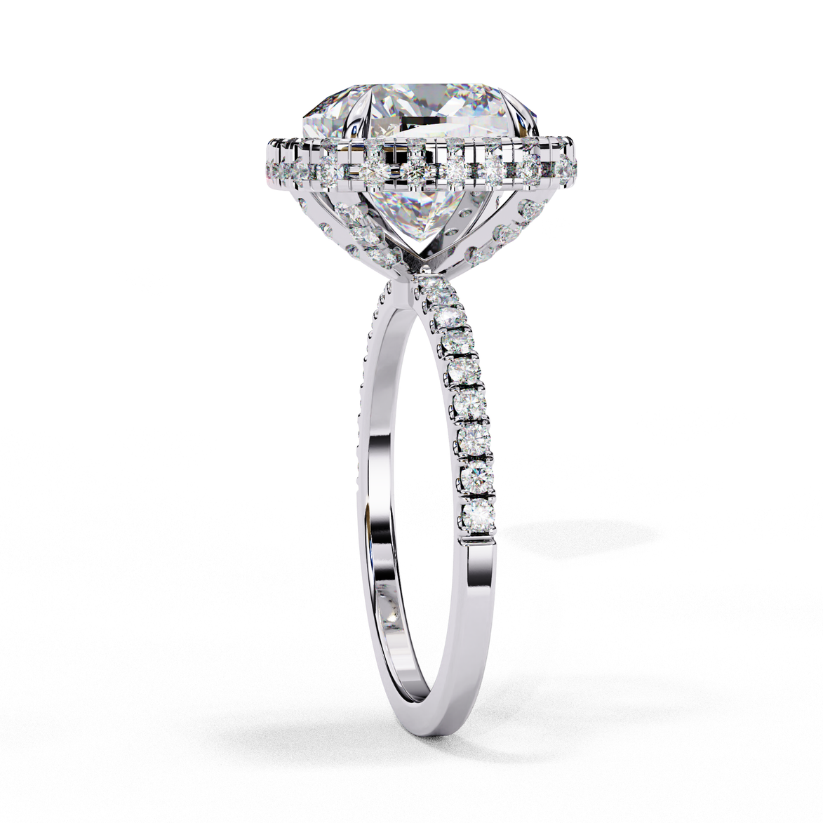 Close-up angled shot of a white gold cushion cut diamond double halo engagement ring highlighting the pavé shoulders.