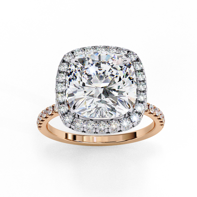 Top-down view of a rose gold cushion cut diamond engagement ring with a brilliant double halo.