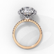 Side profile view of a rose gold cushion cut diamond double halo engagement ring showing the elevated cathedral setting.