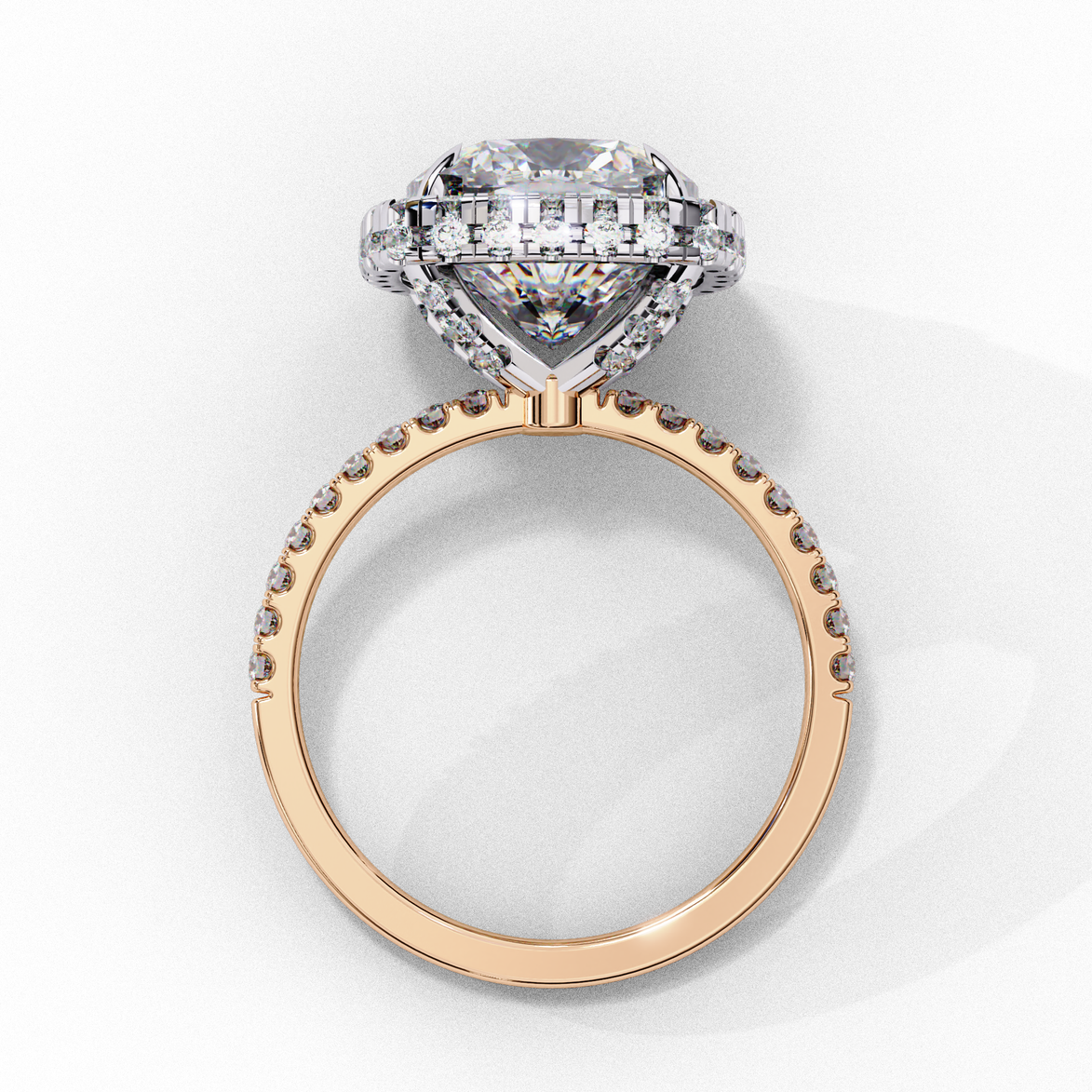Side profile view of a rose gold cushion cut diamond double halo engagement ring showing the elevated cathedral setting.
