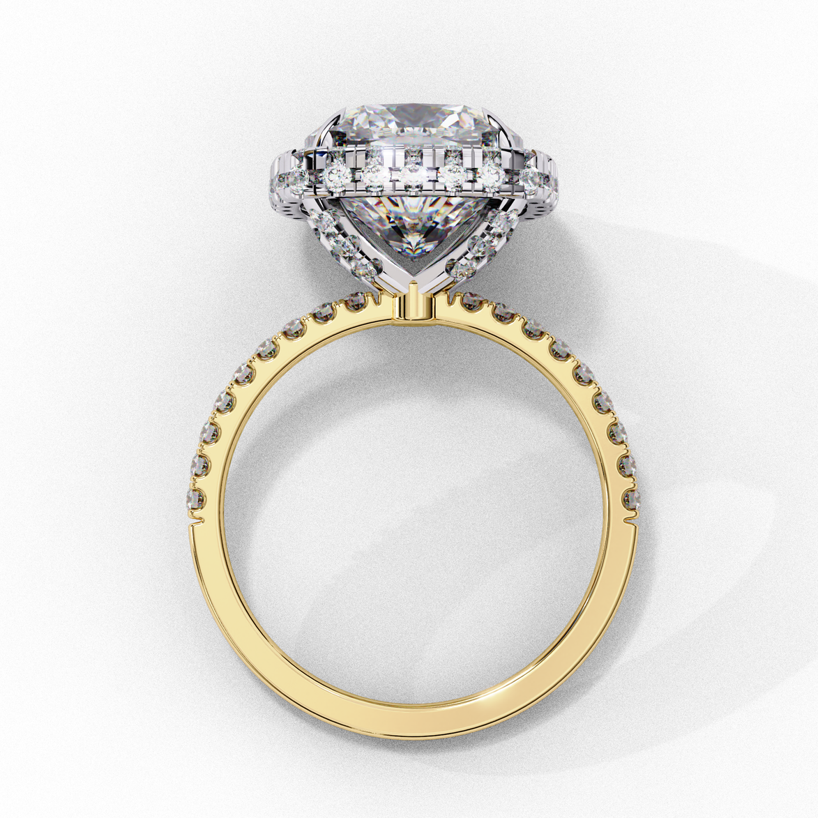 Side profile view of a yellow gold cushion cut diamond double halo engagement ring showing the elevated cathedral setting.