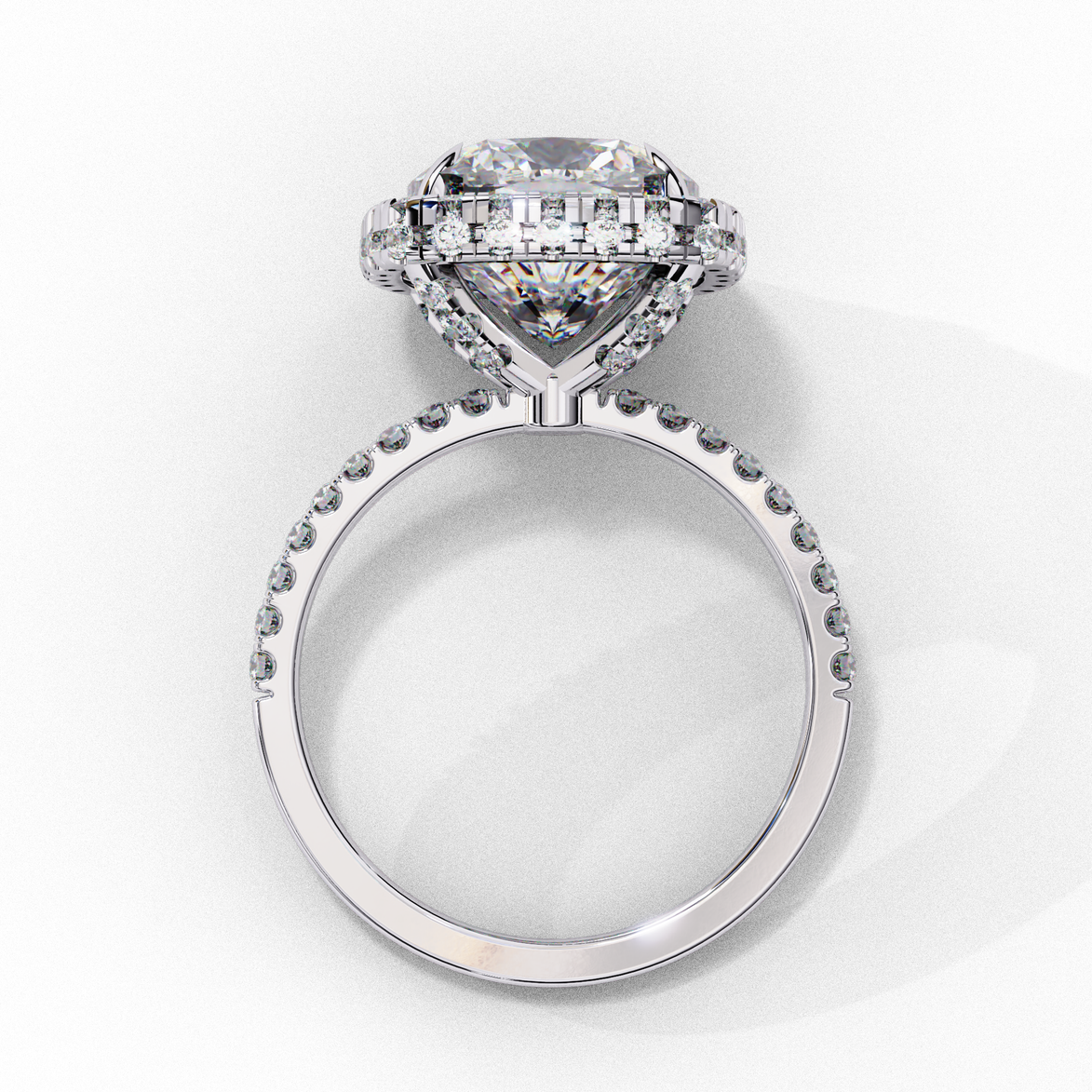 Side profile view of a white gold cushion cut diamond double halo engagement ring showing the elevated cathedral setting.