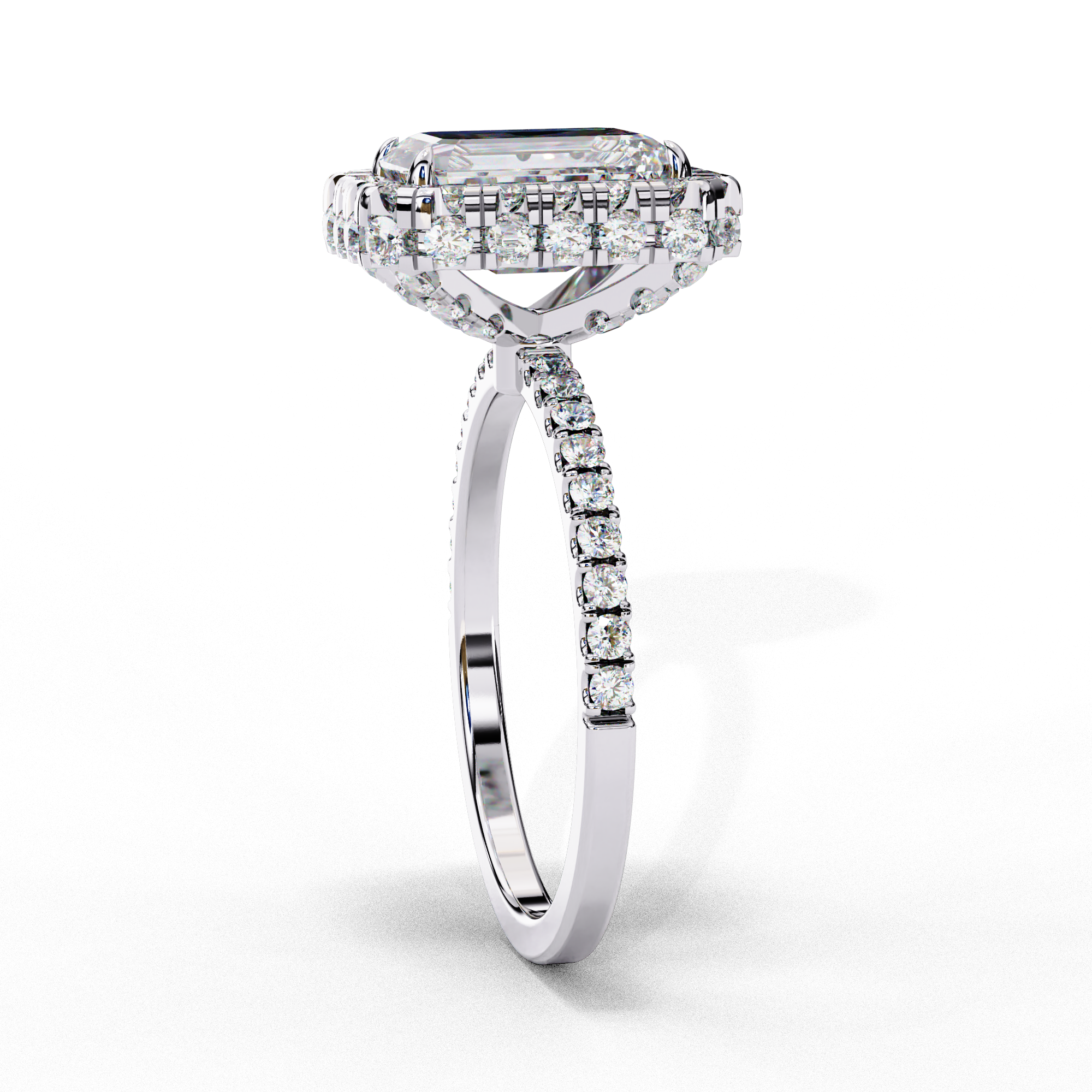 Side profile view of a white gold emerald cut diamond ring showing the diamond-accented pavé band.