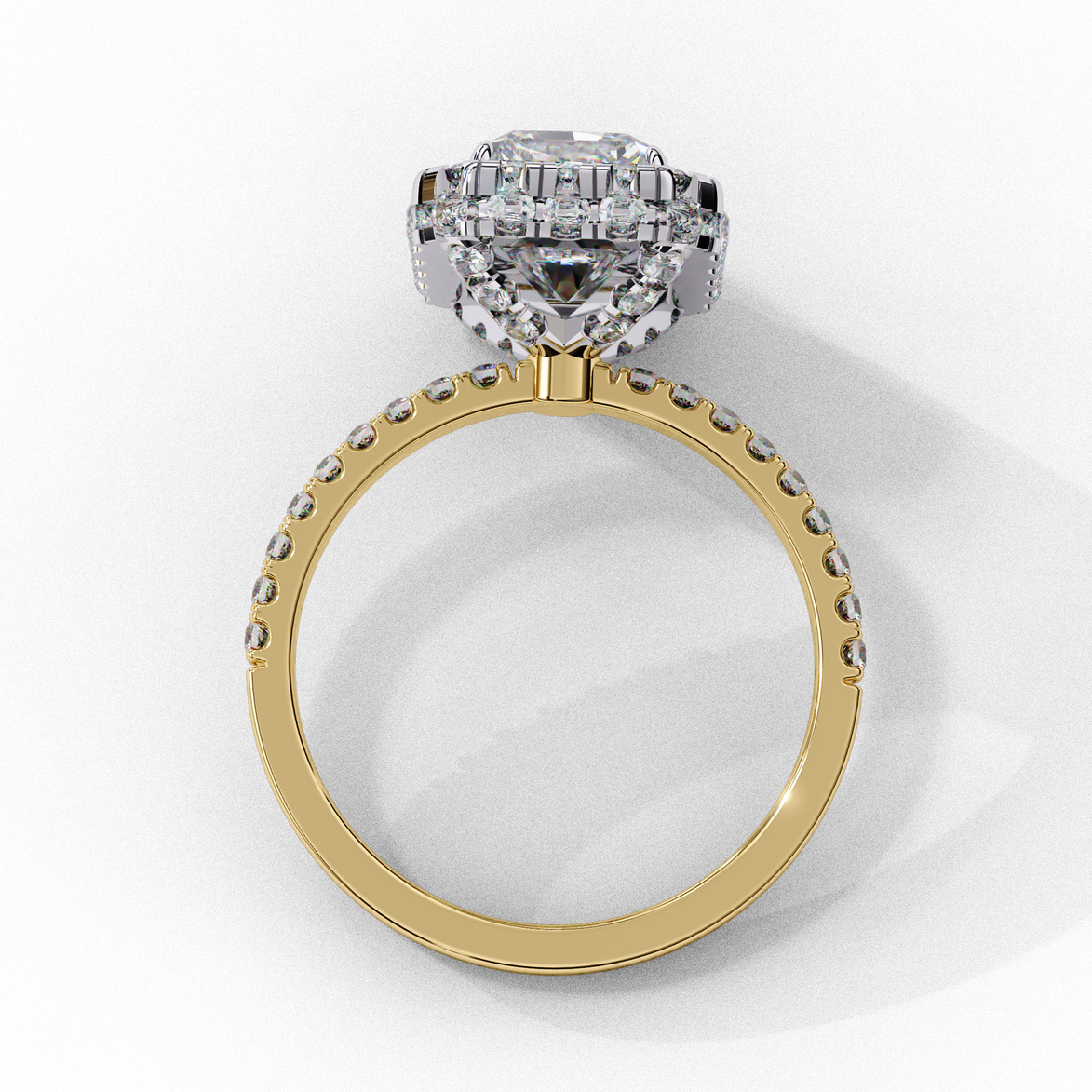 Side profile view of a yellow gold emerald cut diamond double halo engagement ring showing the cathedral setting.