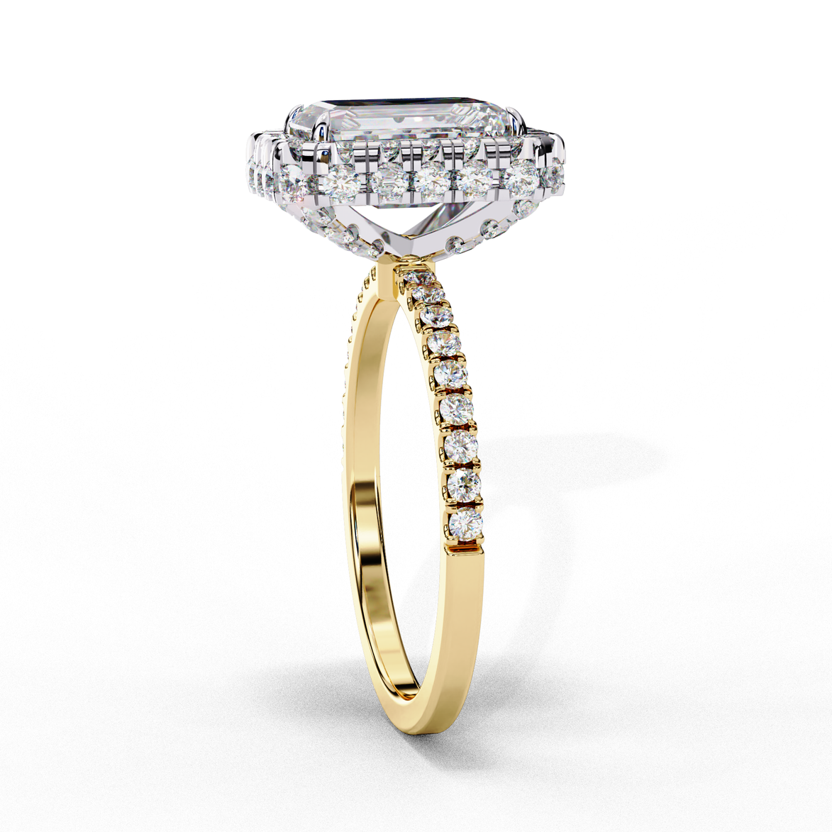 Side profile view of a yellow gold emerald cut diamond double halo engagement ring showing the elevated cathedral gallery.