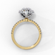 Side profile view of a yellow gold pear shaped diamond halo engagement ring showing the elevated cathedral gallery.