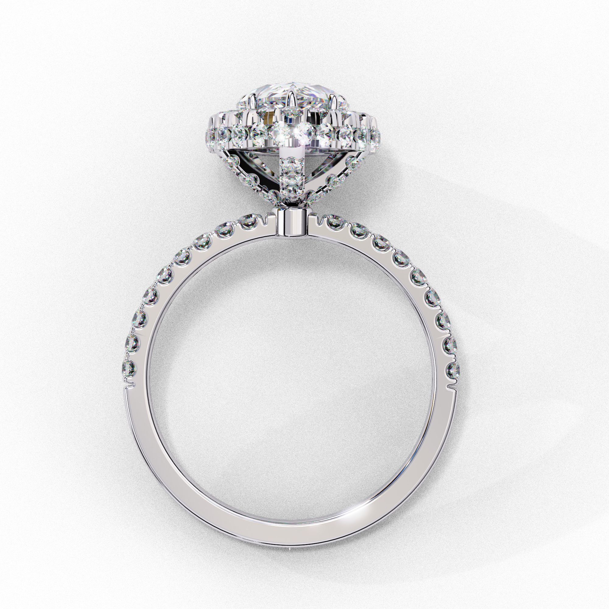 Side profile view of a white gold pear shaped diamond halo engagement ring showing the elevated cathedral gallery.