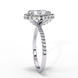 Side profile view of a white gold pear shaped diamond halo engagement ring showing the elevated cathedral gallery.