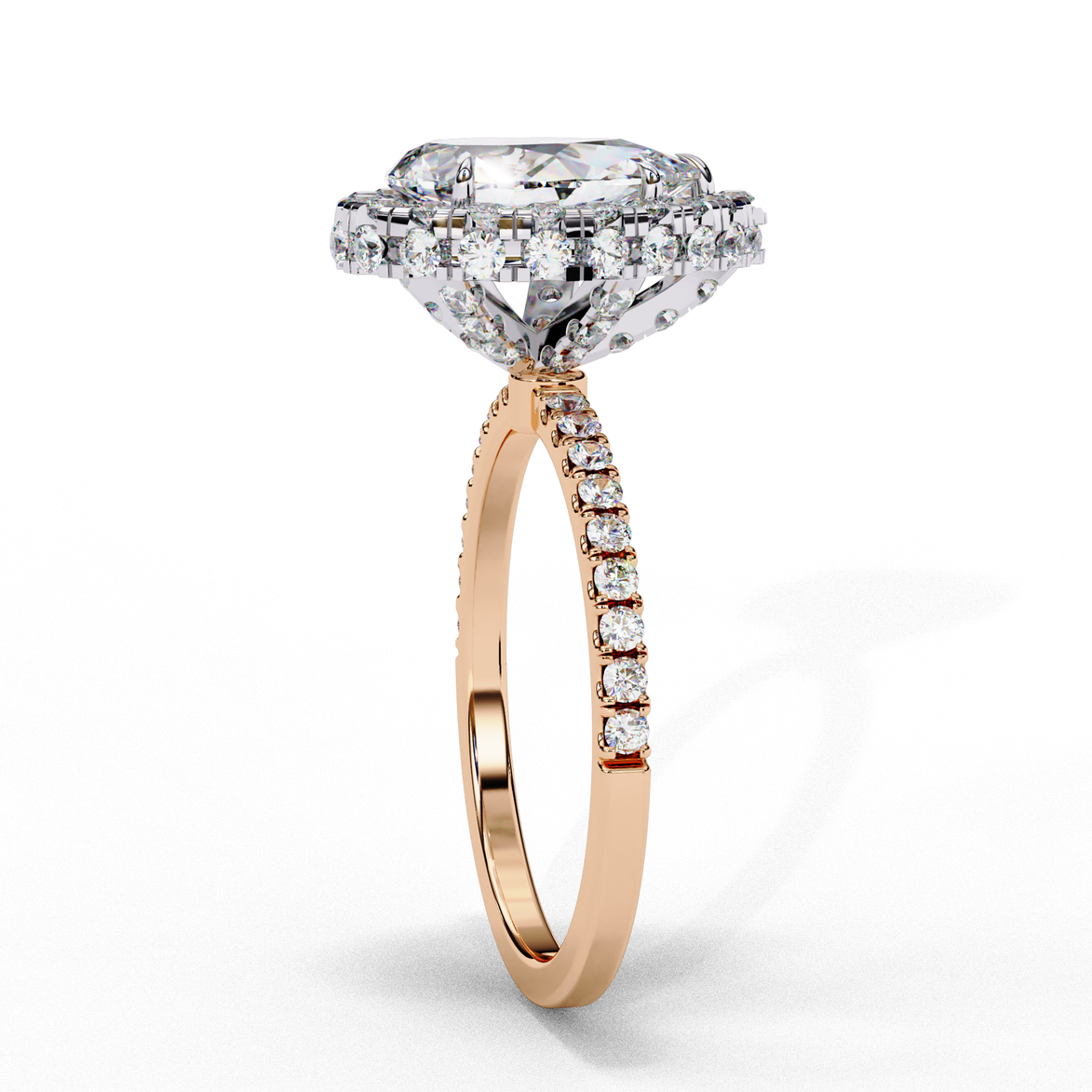 Side profile view of a rose gold pear shaped diamond halo engagement ring showing the elevated cathedral gallery.