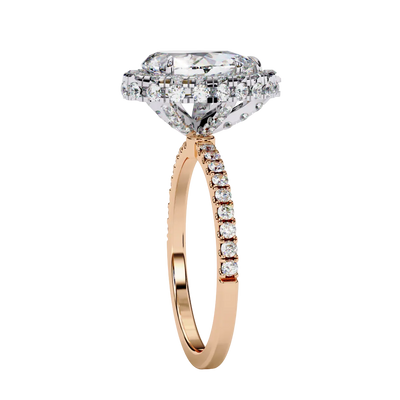 Side profile view of a rose gold pear shaped diamond halo engagement ring showing the elevated cathedral gallery.