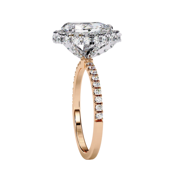 Side profile view of a rose gold pear shaped diamond halo engagement ring showing the elevated cathedral gallery.
