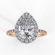 Front view of a rose gold pear shaped diamond halo engagement ring.