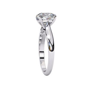 Side profile view of a white gold round brilliant cut diamond solitaire engagement ring.