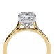 Close-up angled shot from beneath the basket of a yellow gold round brilliant cut diamond solitaire ring.