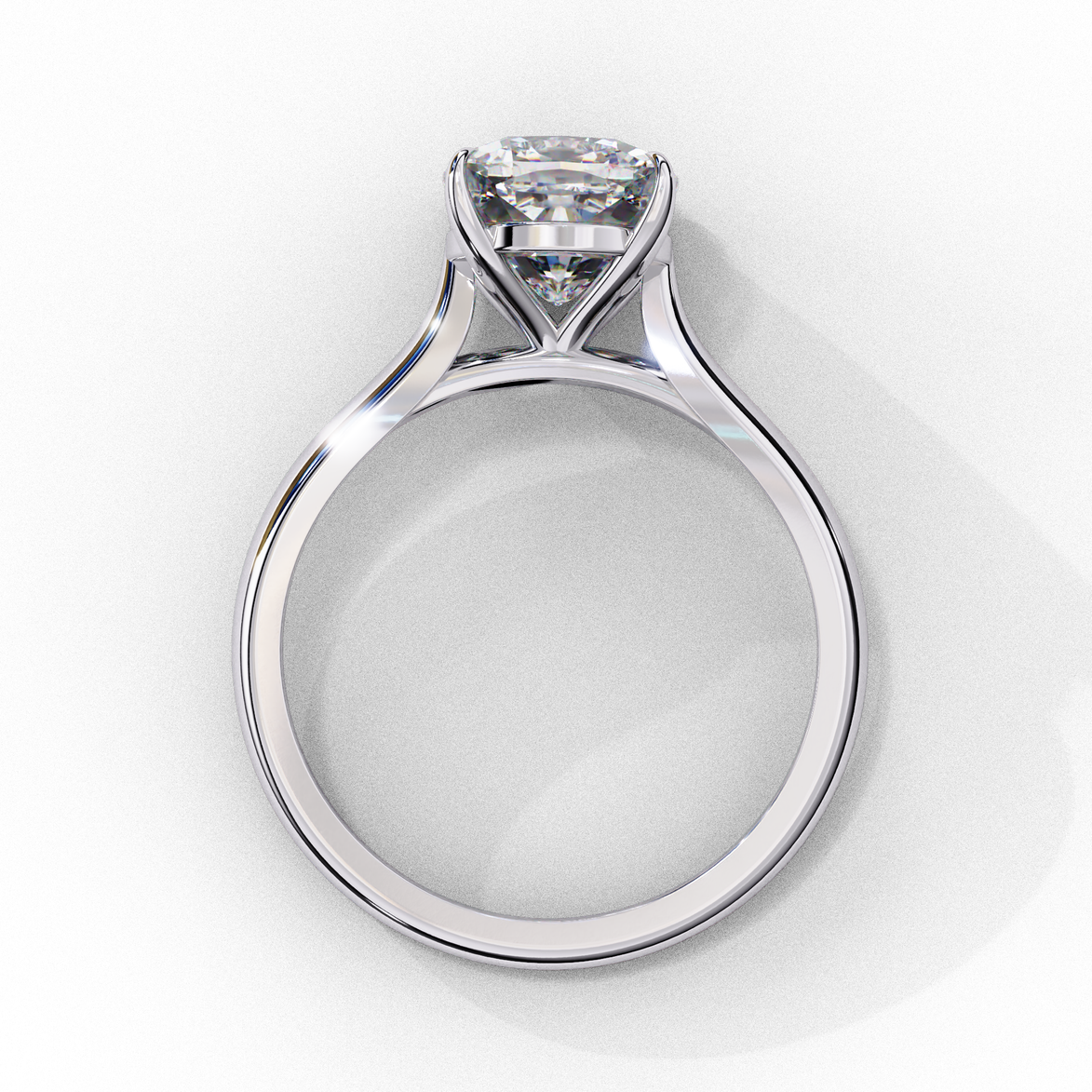 Side profile view of a white gold round brilliant cut diamond solitaire ring showing a classic four-prong head.