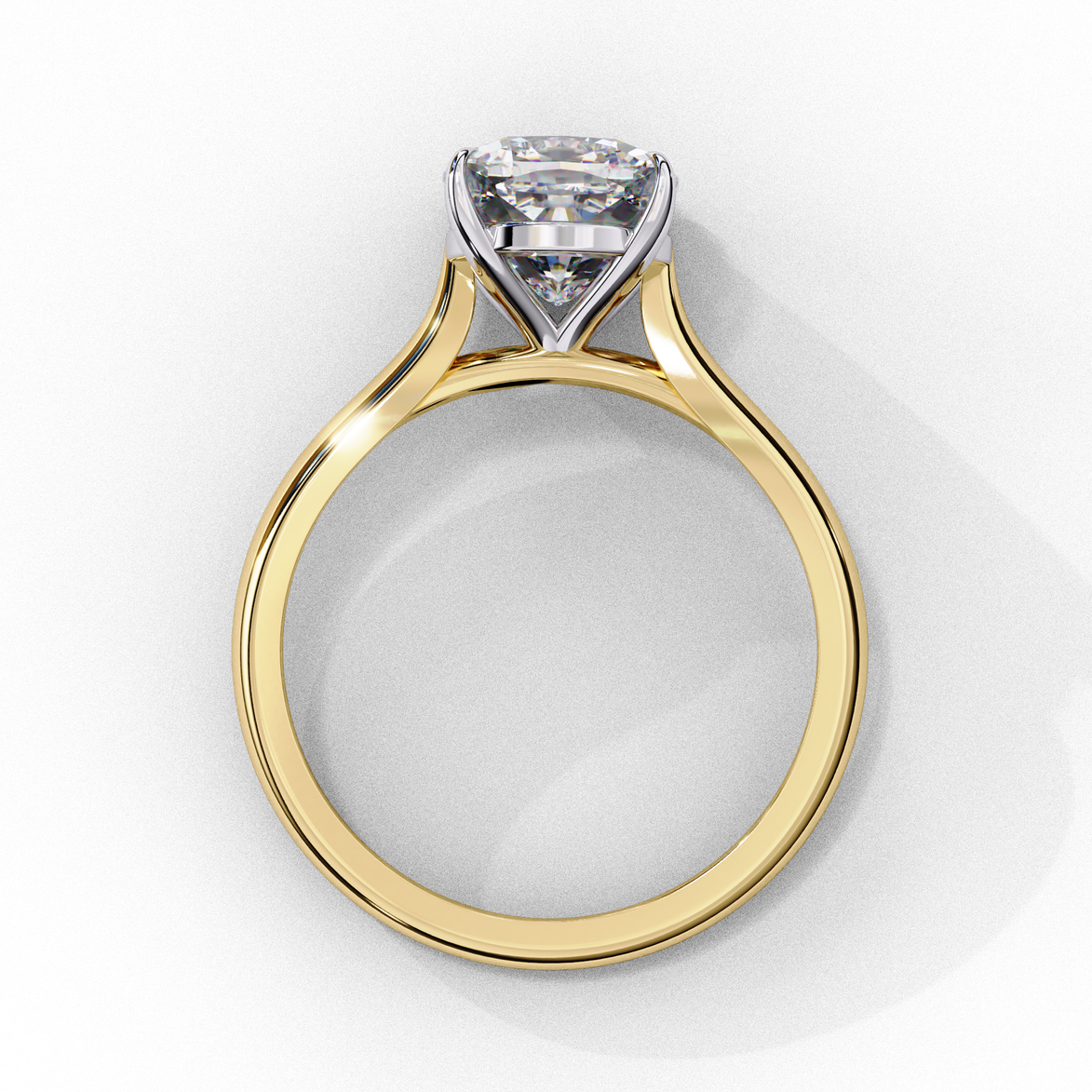 Side profile view of a yellow gold round brilliant cut diamond solitaire ring showing the classic four-prong head layout.