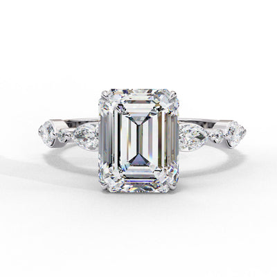 Front view of a white gold emerald cut diamond engagement ring with alternating marquise and round accent diamonds.