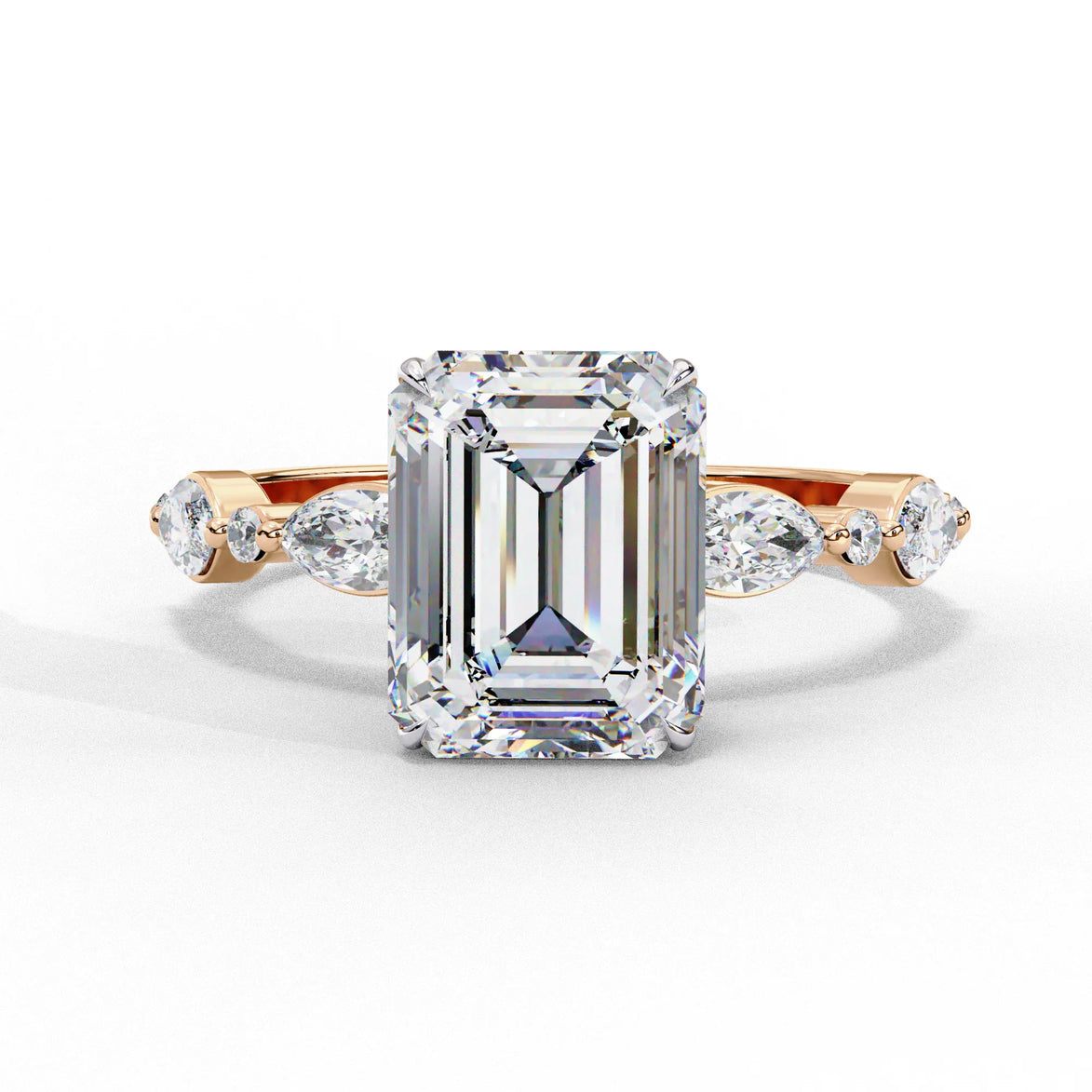Front view of a rose gold emerald cut diamond engagement ring with alternating marquise and round accent diamonds.